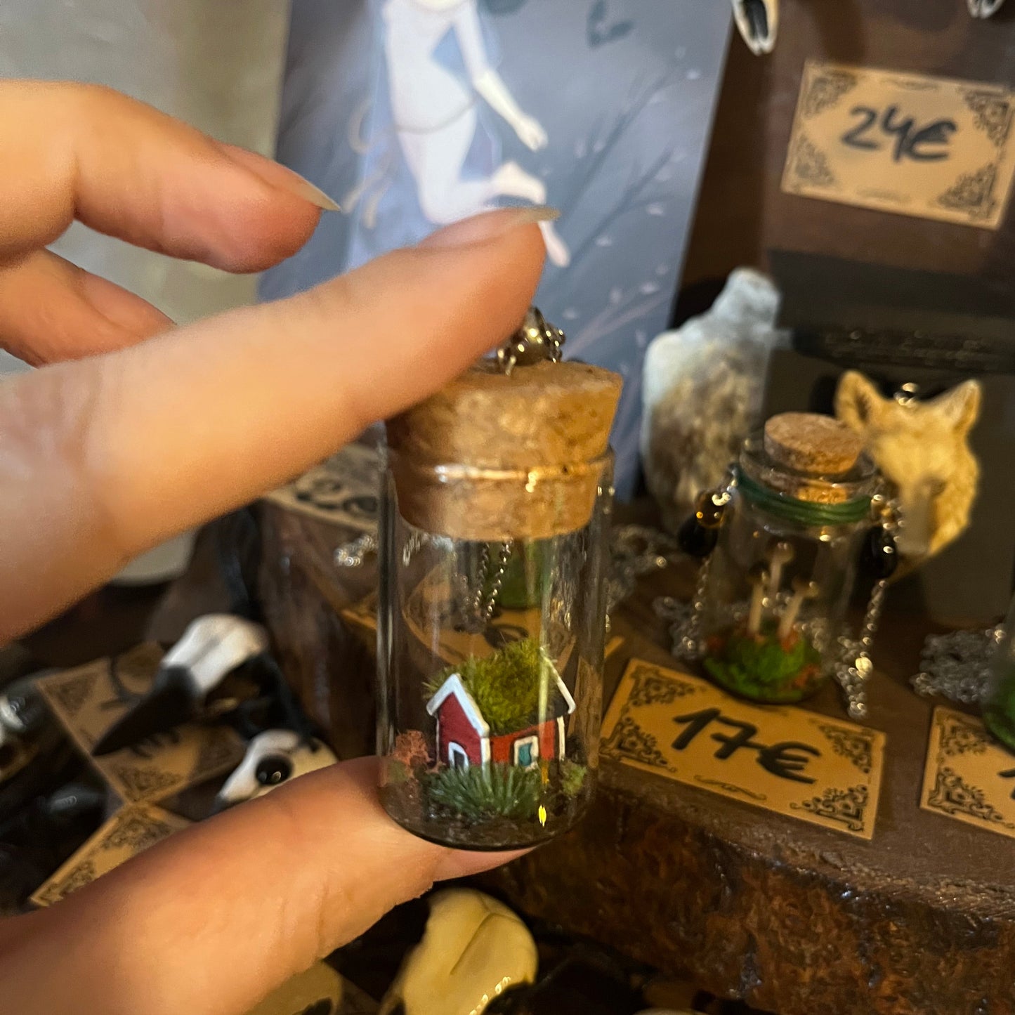 Artisan pendant with tiny red house inside bottle