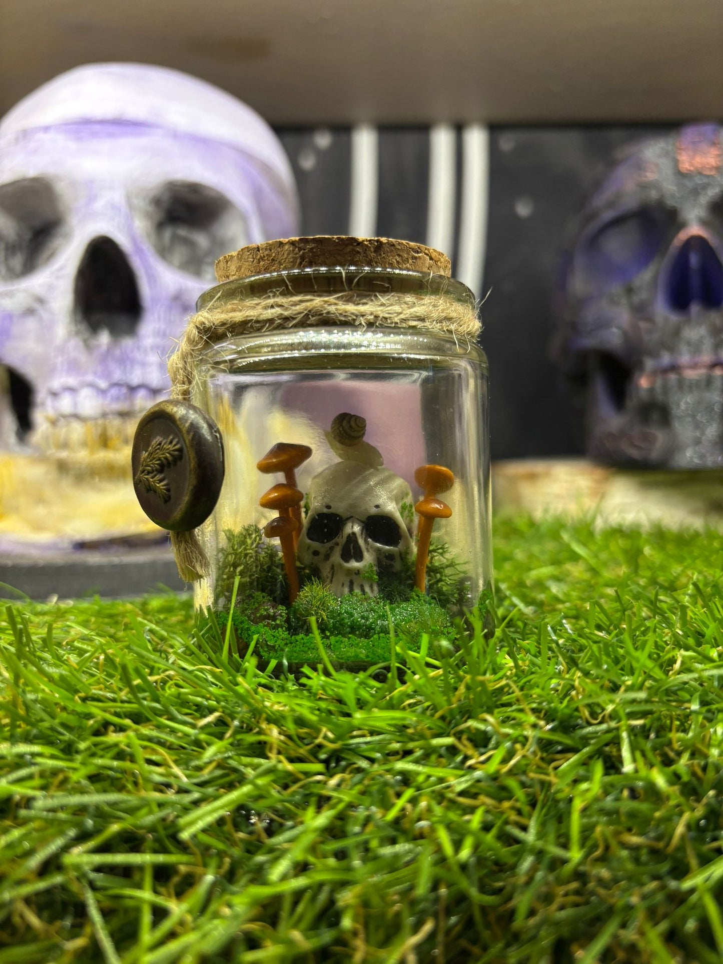 Handmade diorama with magical details inside glass bottle