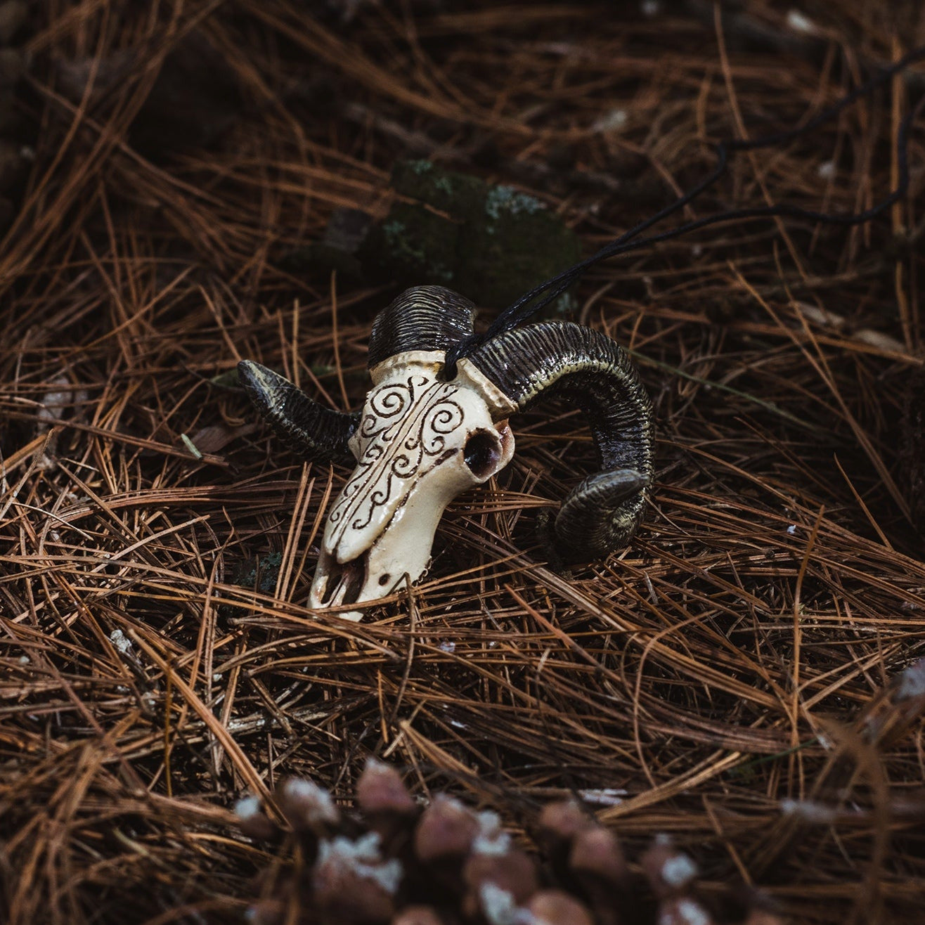 Handcrafted ram skull pendant with occult patterns
