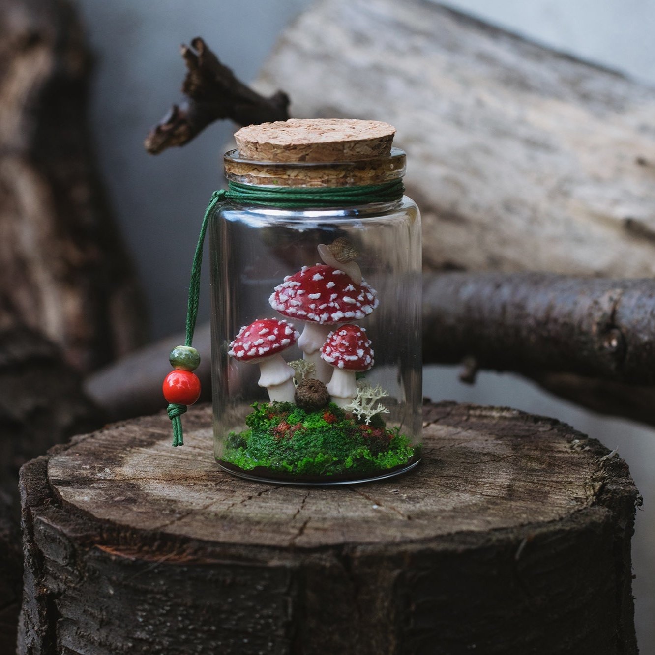 Miniature diorama in a bottle with fly agarics